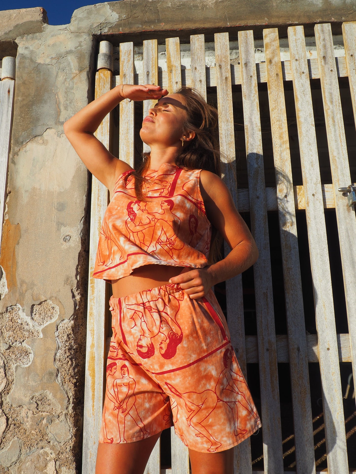 Up-cycled vintage cotton shorts with elastic waist and  printed karma sutra design in burnt orange.