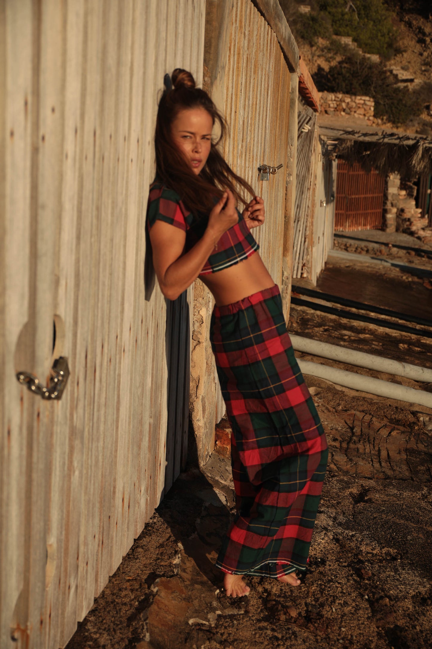 A stunning two-piece upcycled set featuring a vibrant red and blue checked design wide leg pants with elastic waste and crop top.