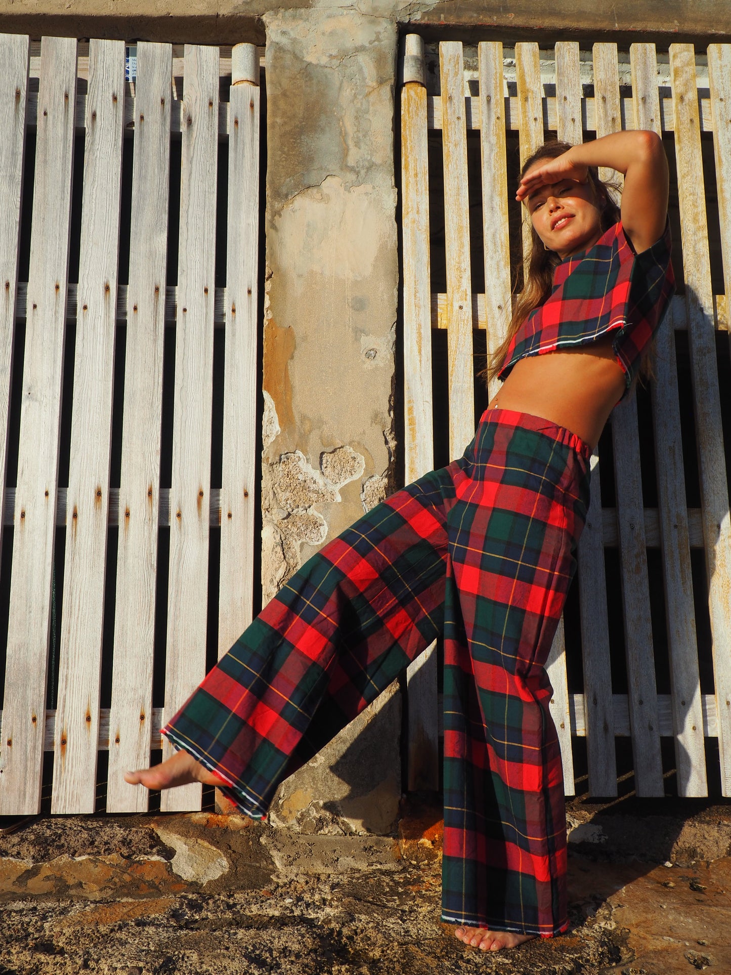 A stunning two-piece upcycled set featuring a vibrant red and blue checked design wide leg pants with elastic waste and crop top.