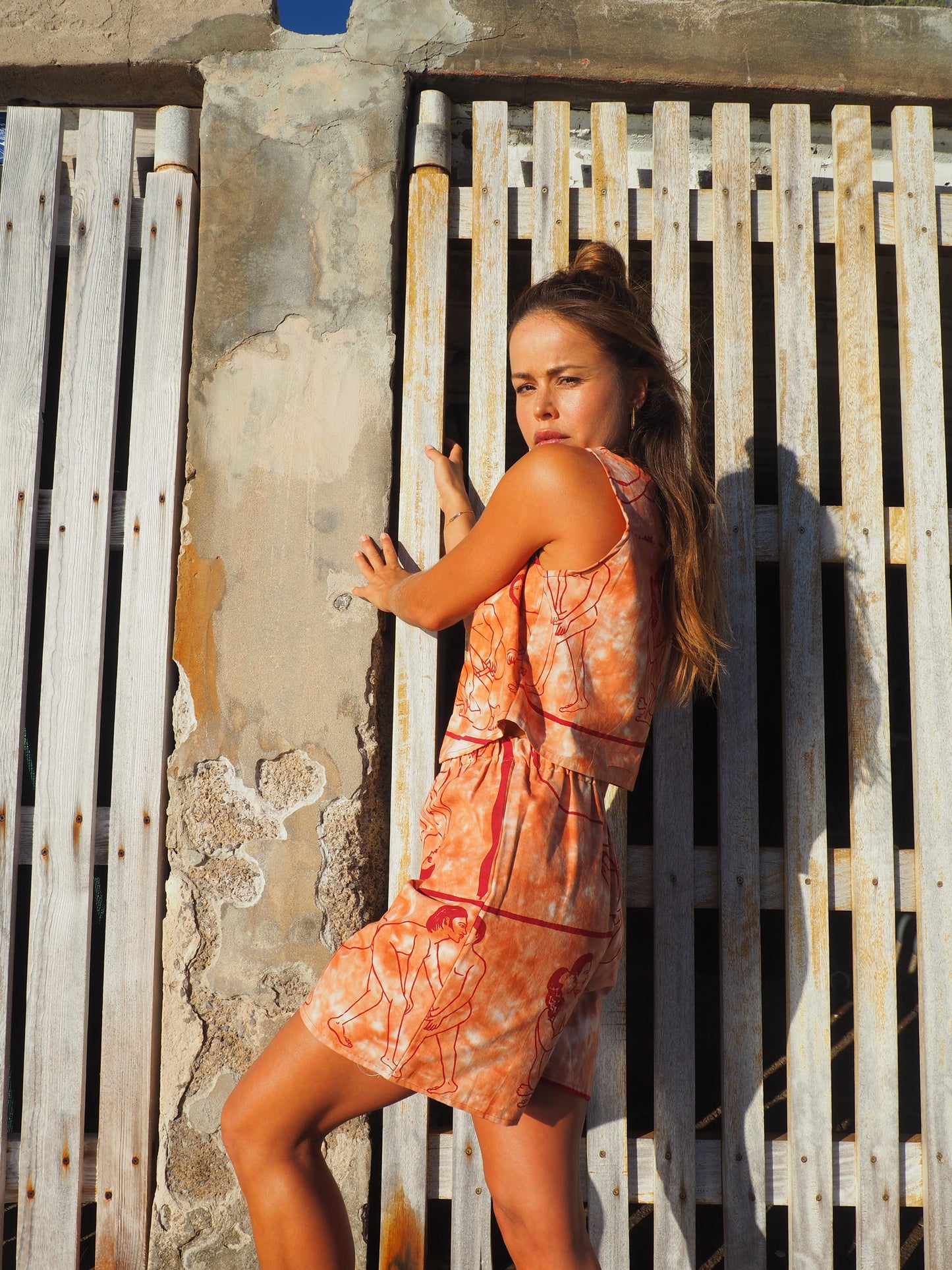 Up-cycled vintage cotton shorts with elastic waist and  printed karma sutra design in burnt orange.