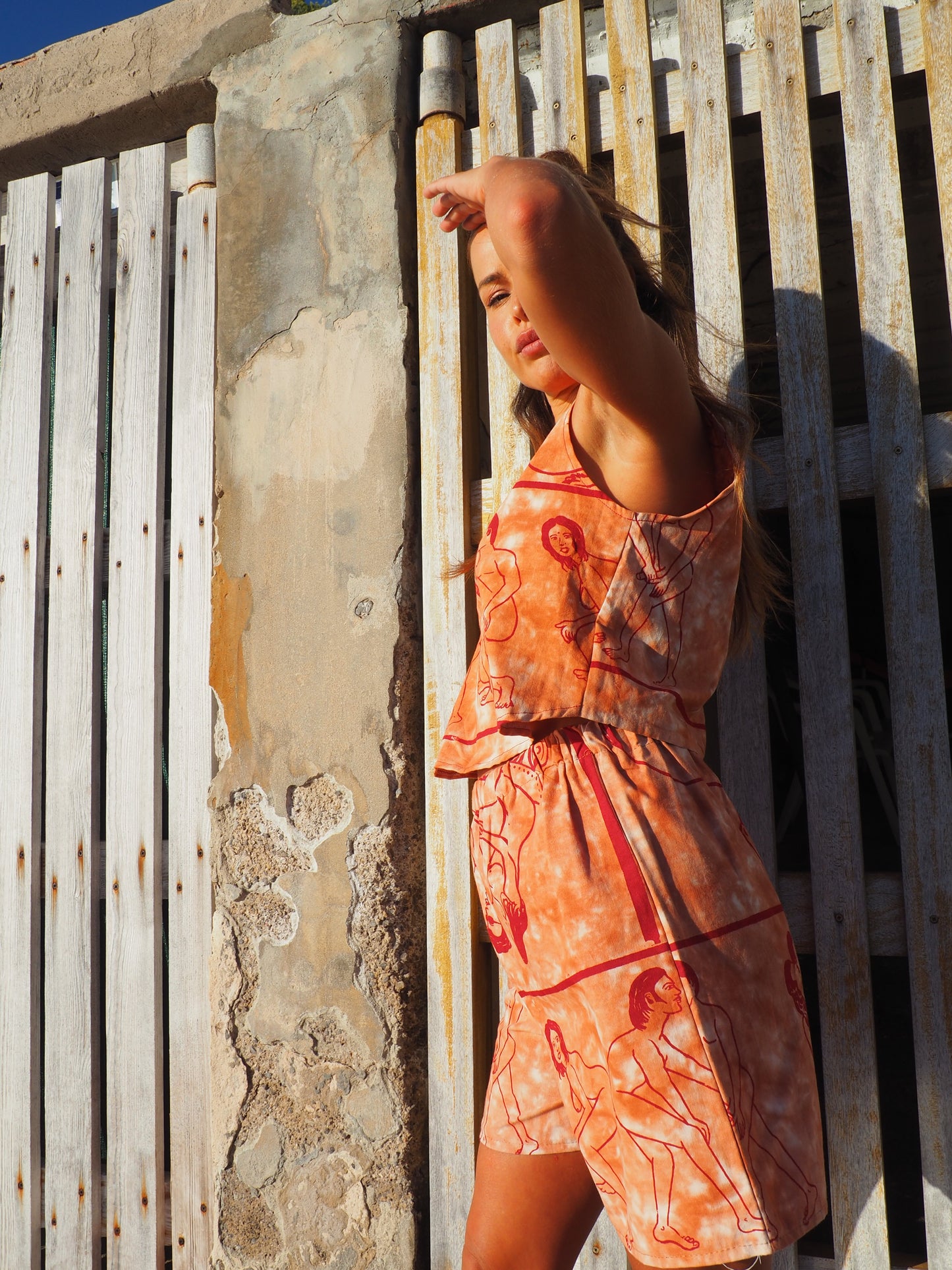 Up-cycled vintage cotton shorts with elastic waist and  printed karma sutra design in burnt orange.