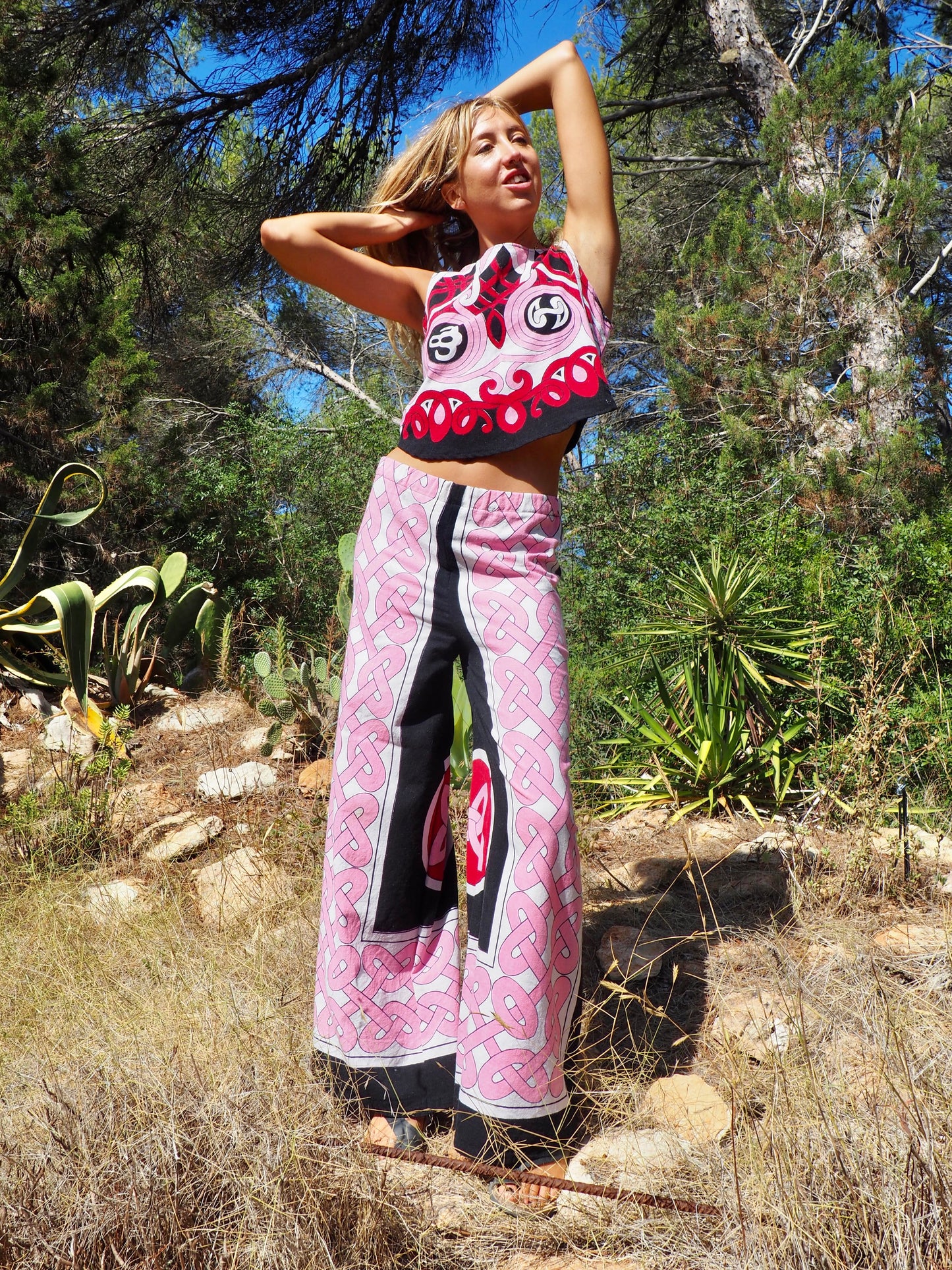 Up-cycled cotton short sleeve crop top in pink and black with vibrant print design and circular motifs by Vagabond Ibiza made