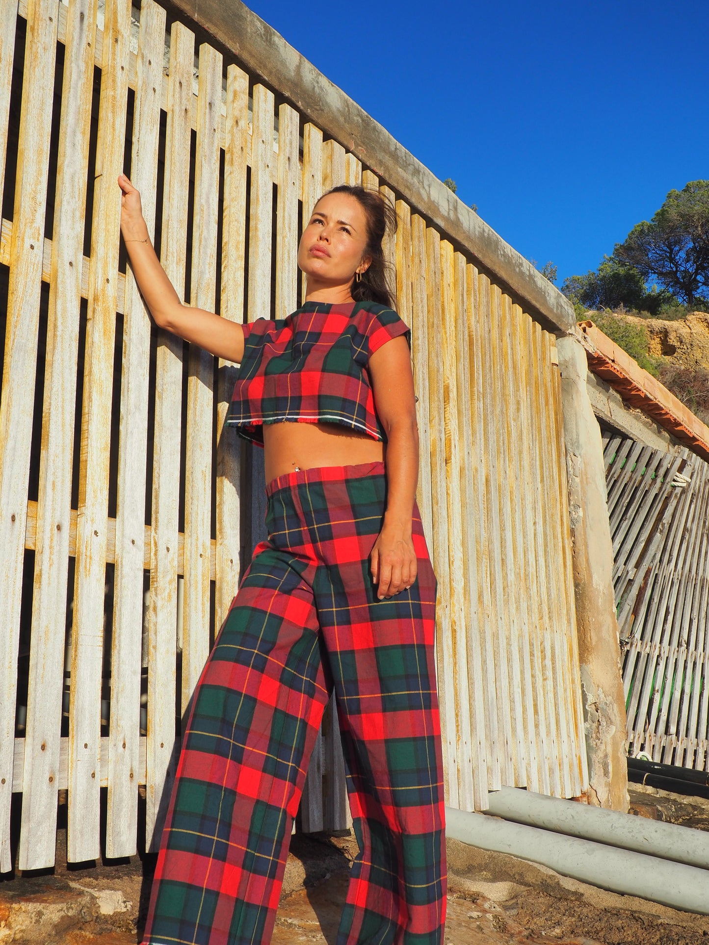 A stunning two-piece upcycled set featuring a vibrant red and blue checked design wide leg pants with elastic waste and crop top.