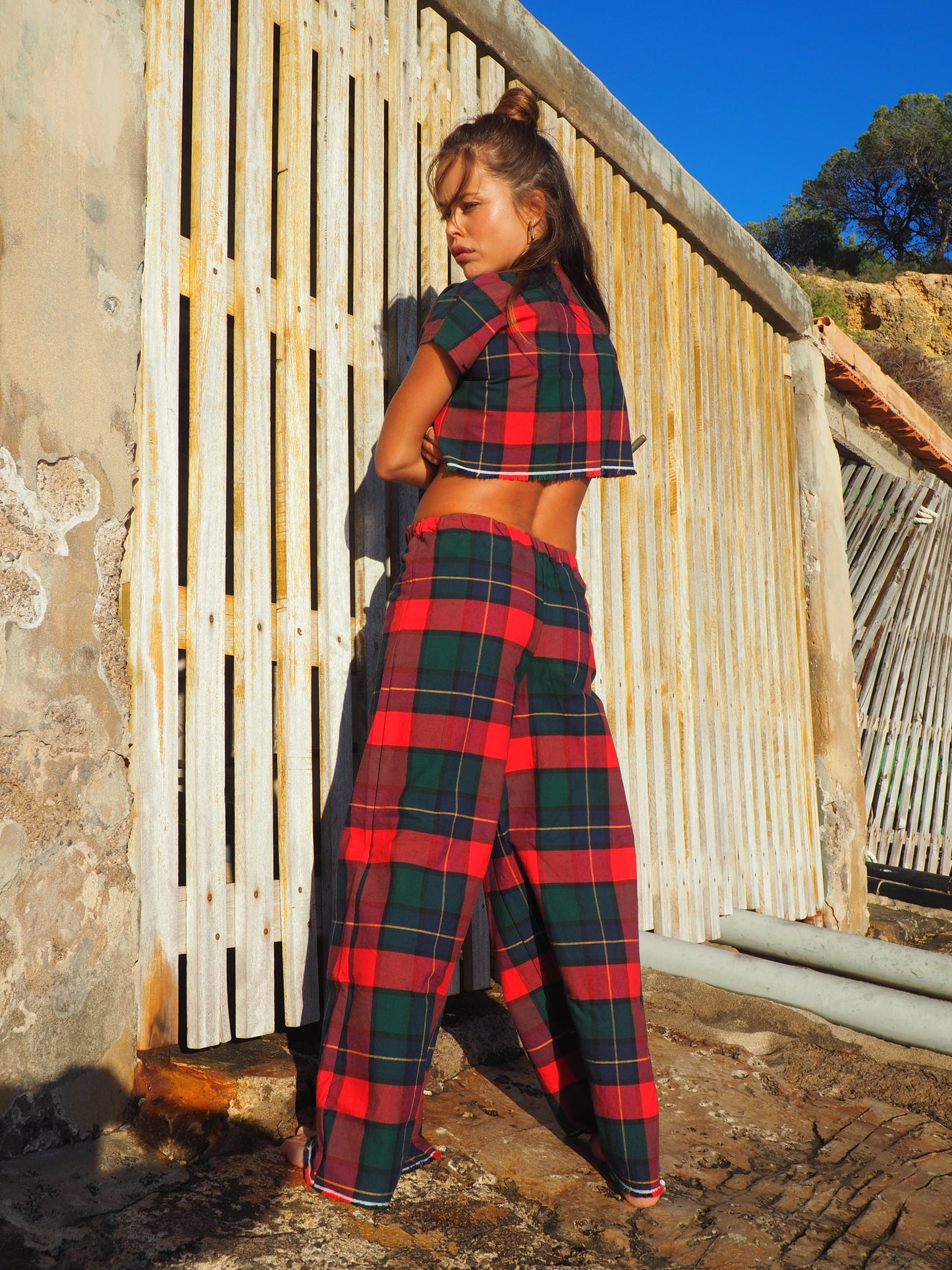 A stunning two-piece upcycled set featuring a vibrant red and blue checked design wide leg pants with elastic waste and crop top.