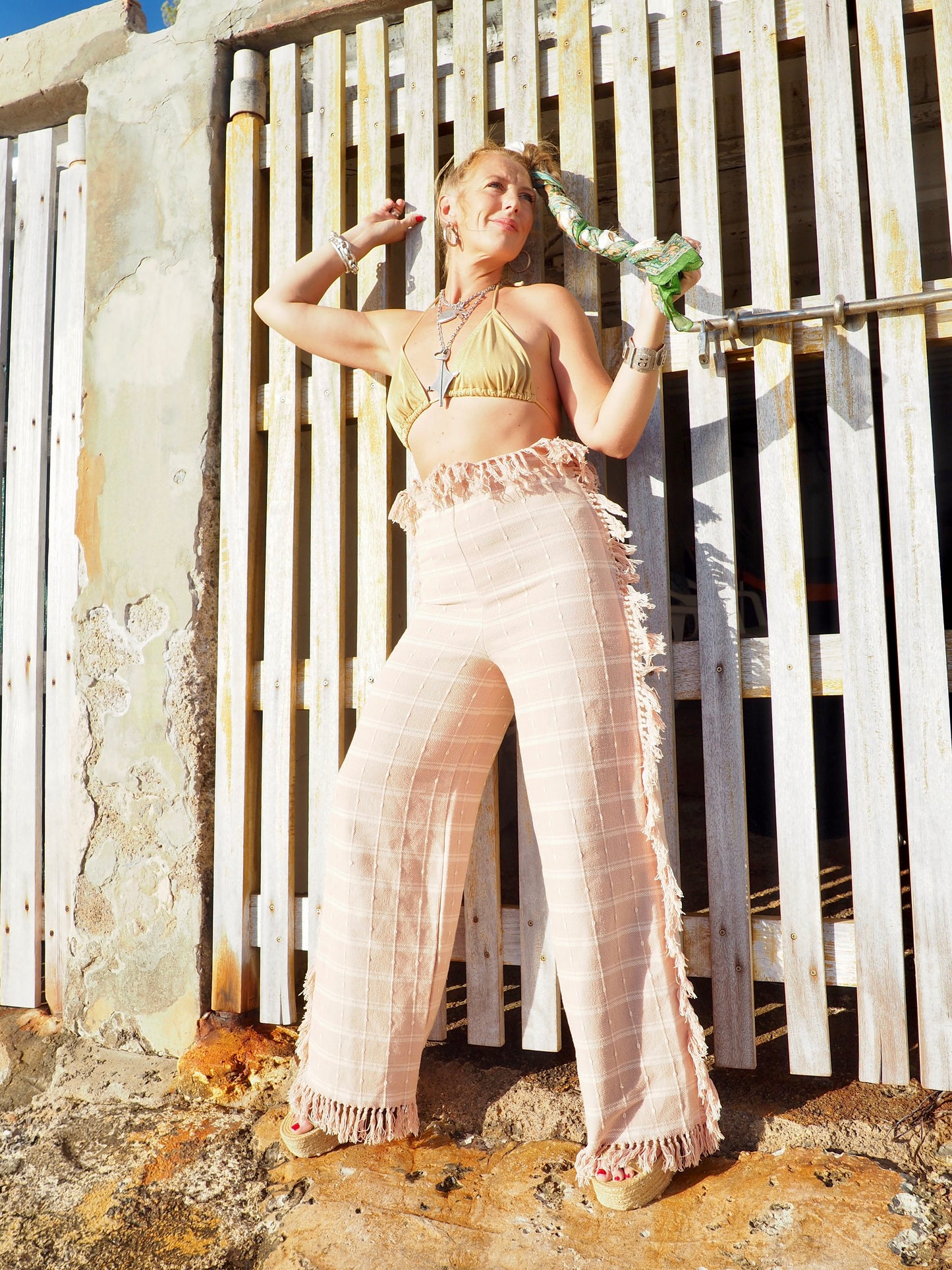 Wide leg pants with elastic waste made by vagabond Ibiza from vintage woven cotton tassel blanket with tassel side trim.