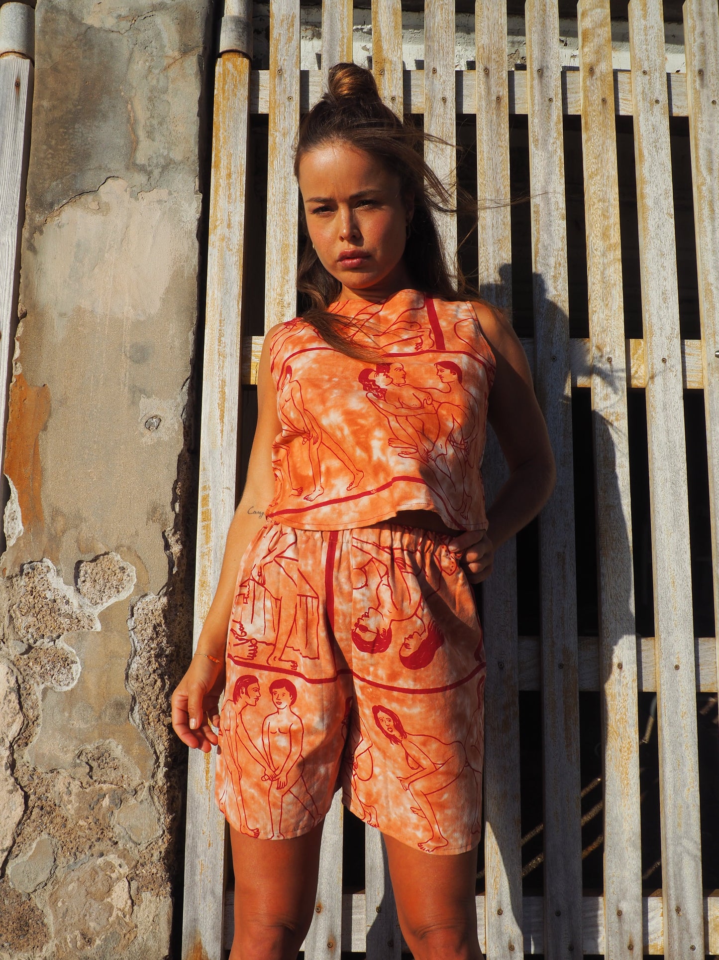 Up-cycled vintage cotton shorts with elastic waist and  printed karma sutra design in burnt orange.