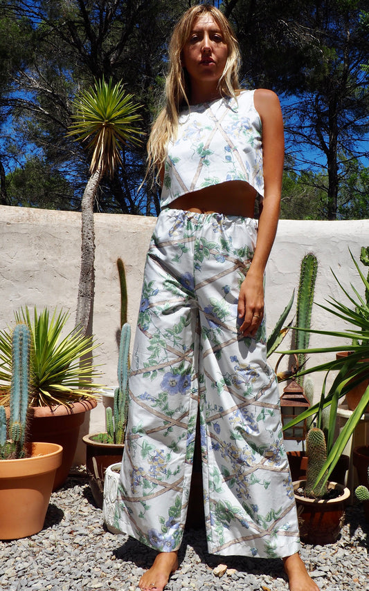 Up-cycled vintage garden floral printed textiles in white and blue wide leg pants with elasticated waist for fit by Vagabond Ibiza