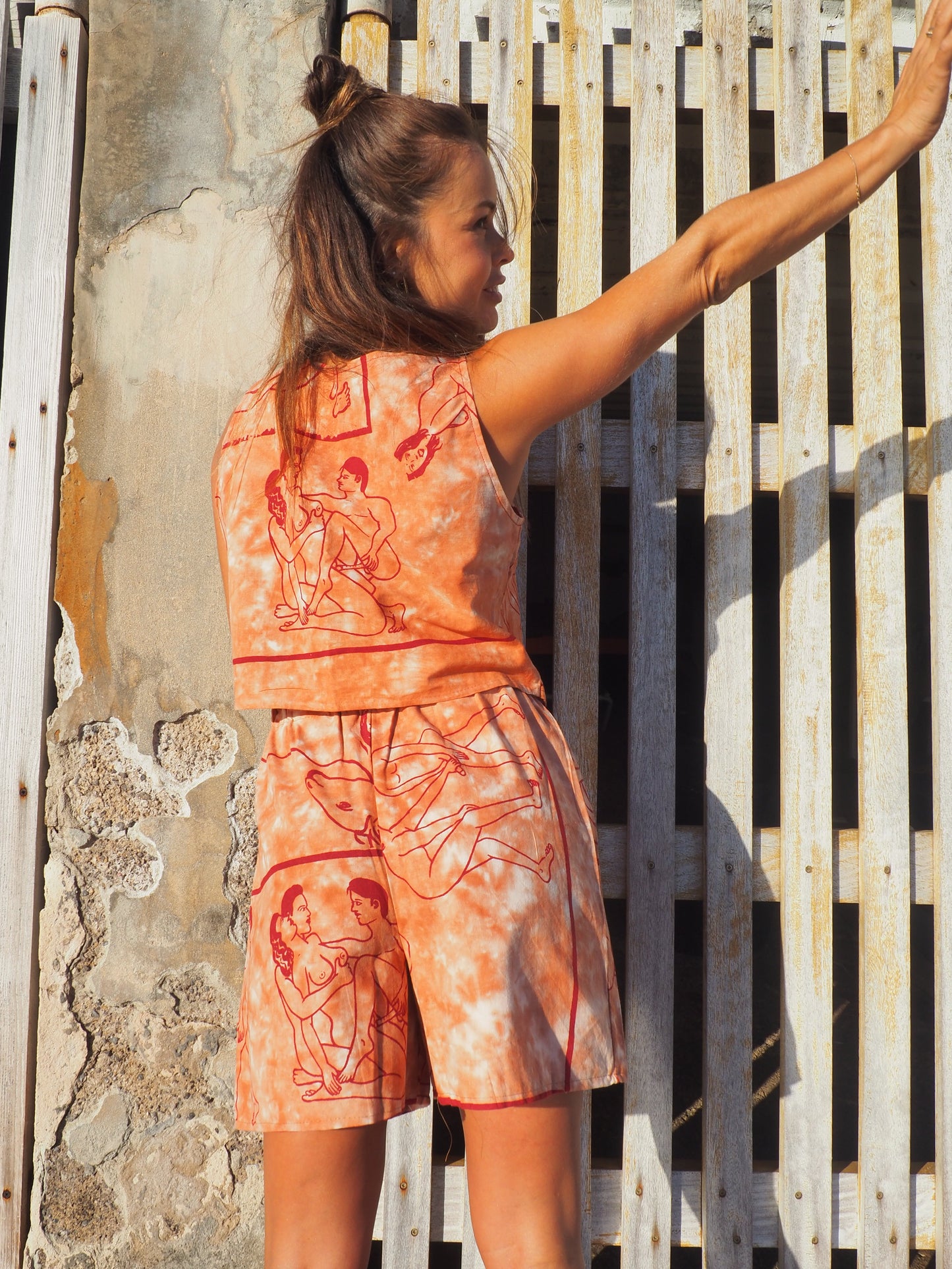 Up-cycled vintage cotton shorts with elastic waist and  printed karma sutra design in burnt orange.