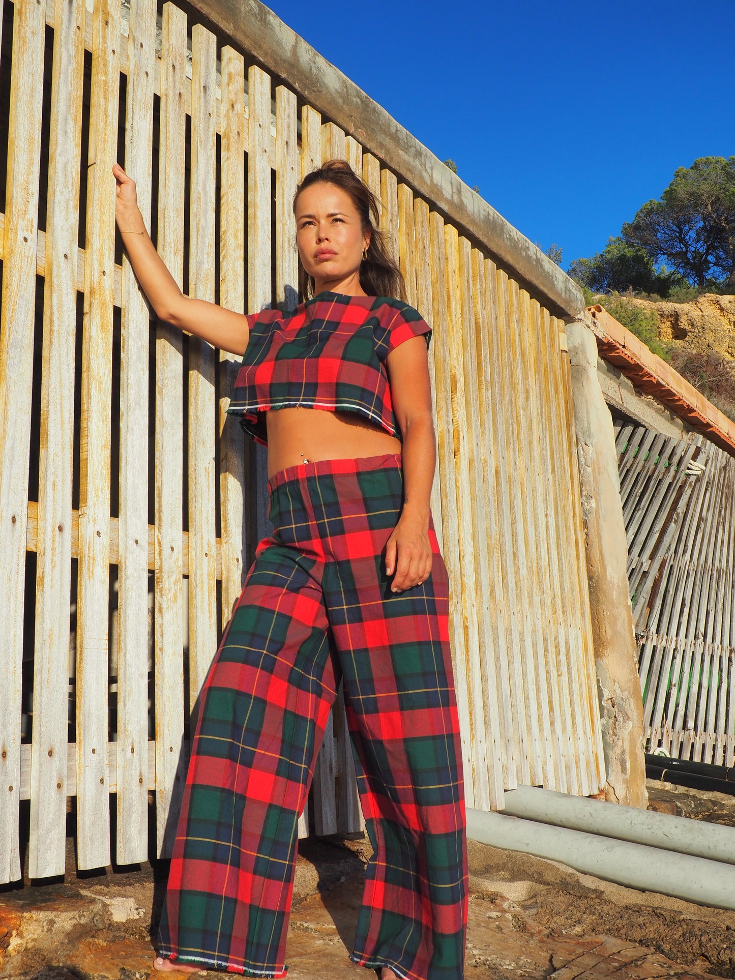 A stunning two-piece upcycled set featuring a vibrant red and blue checked design wide leg pants with elastic waste and crop top.