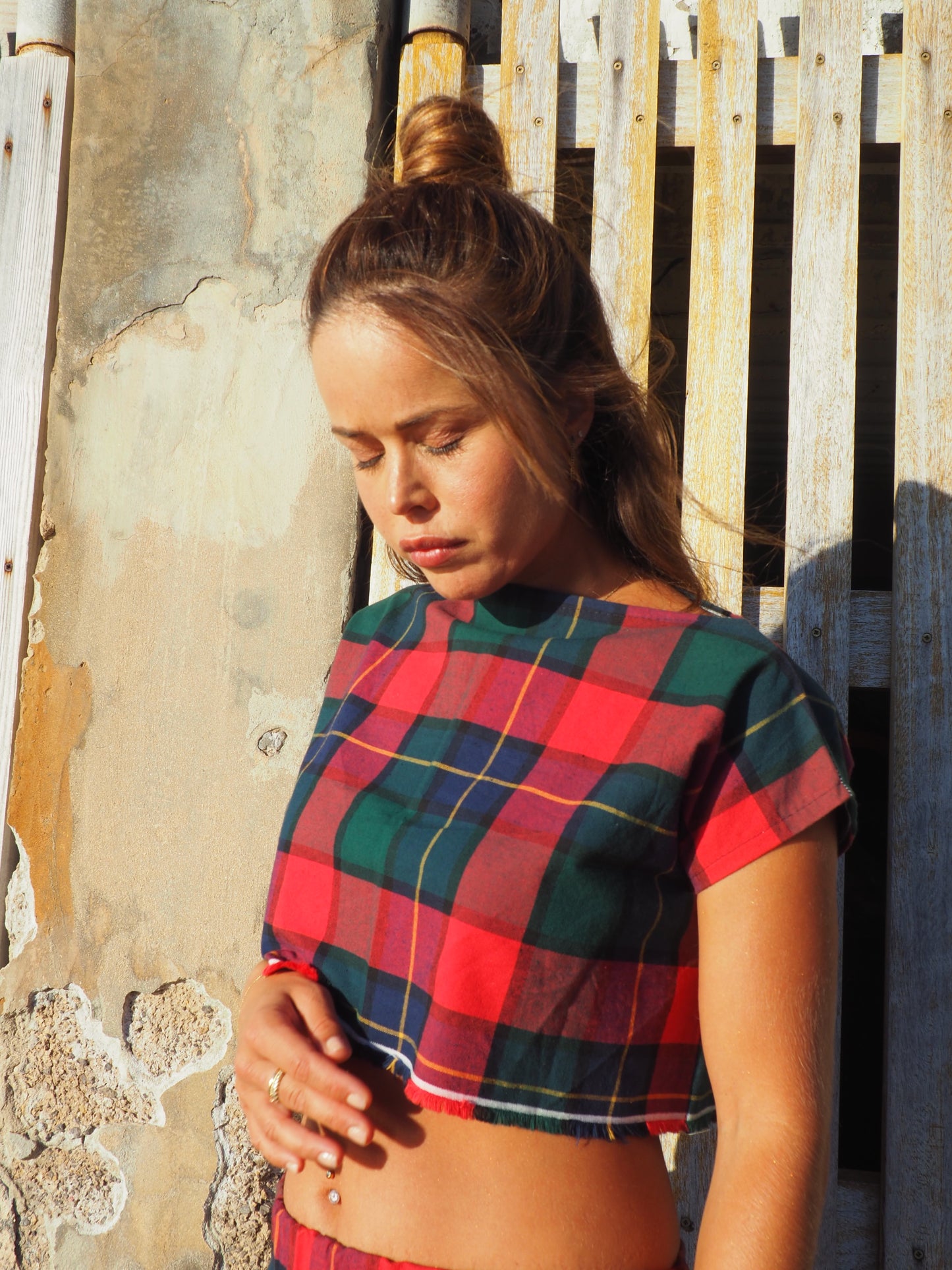 A stunning two-piece upcycled set featuring a vibrant red and blue checked design wide leg pants with elastic waste and crop top.