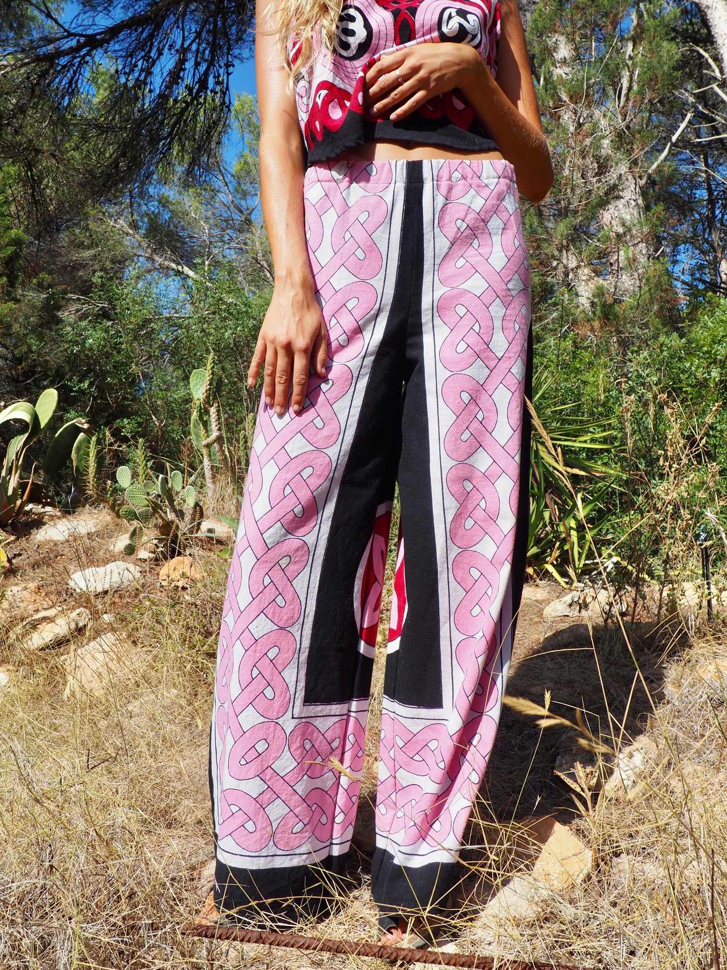 Up-cycled cotton wide leg pants pink and black with vibrant print design and circular motifs by Vagabond Ibiza