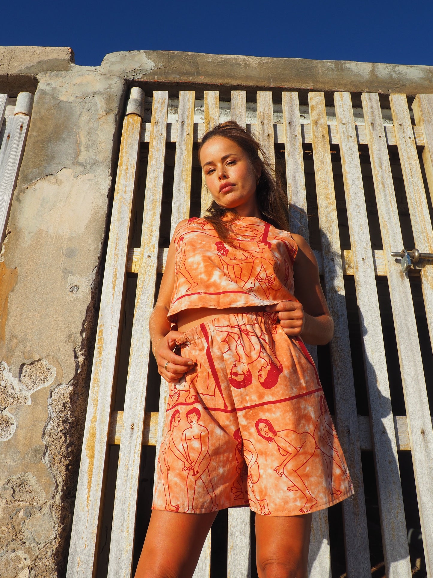 Up-cycled vintage cotton shorts with elastic waist and  printed karma sutra design in burnt orange.