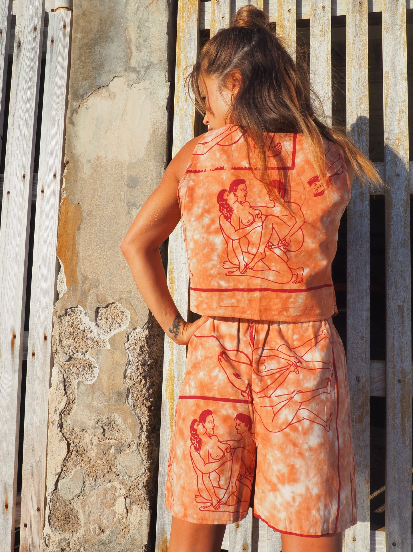 Up-cycled vintage cotton shorts with elastic waist and  printed karma sutra design in burnt orange.