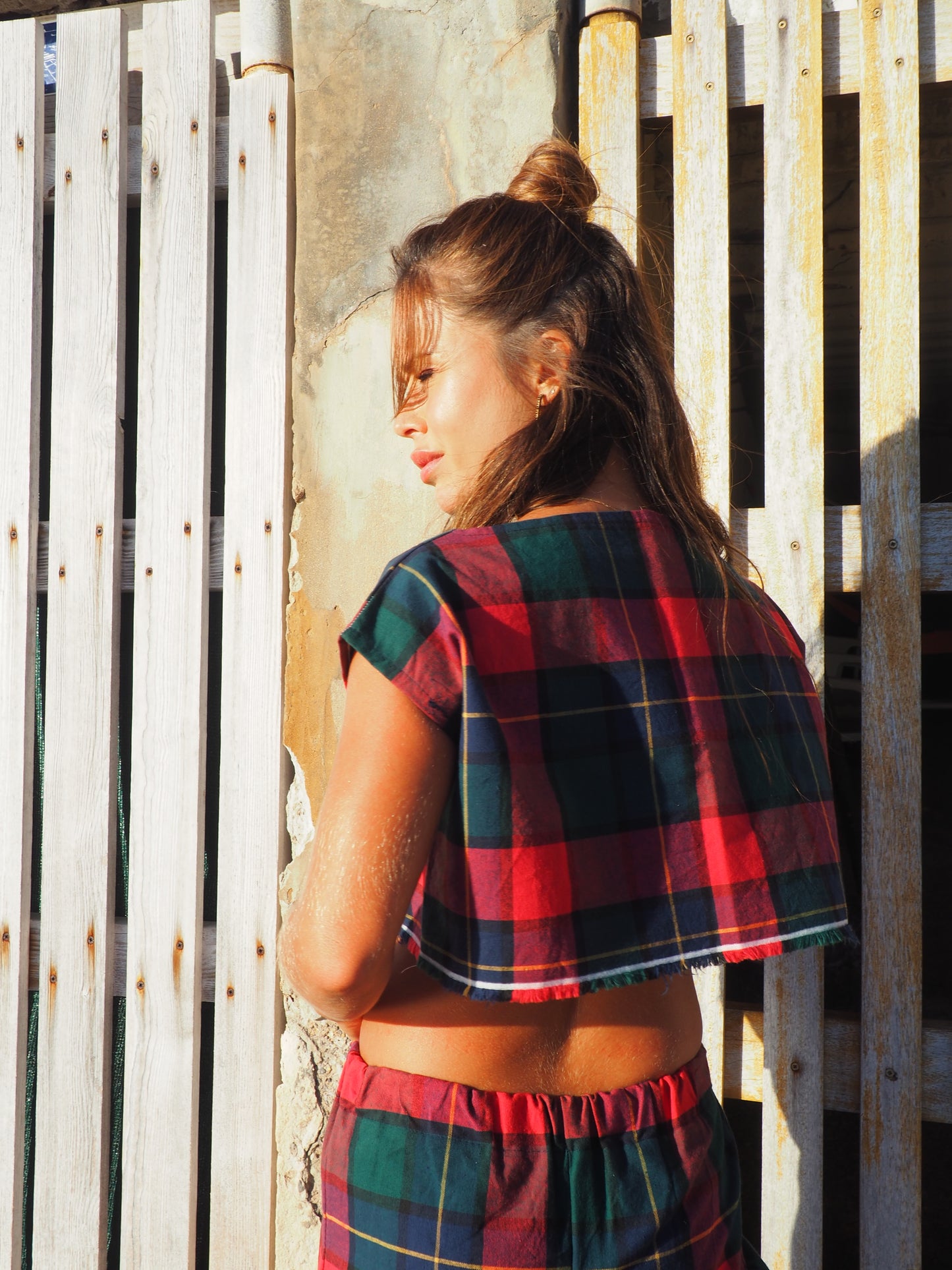 A stunning two-piece upcycled set featuring a vibrant red and blue checked design wide leg pants with elastic waste and crop top.