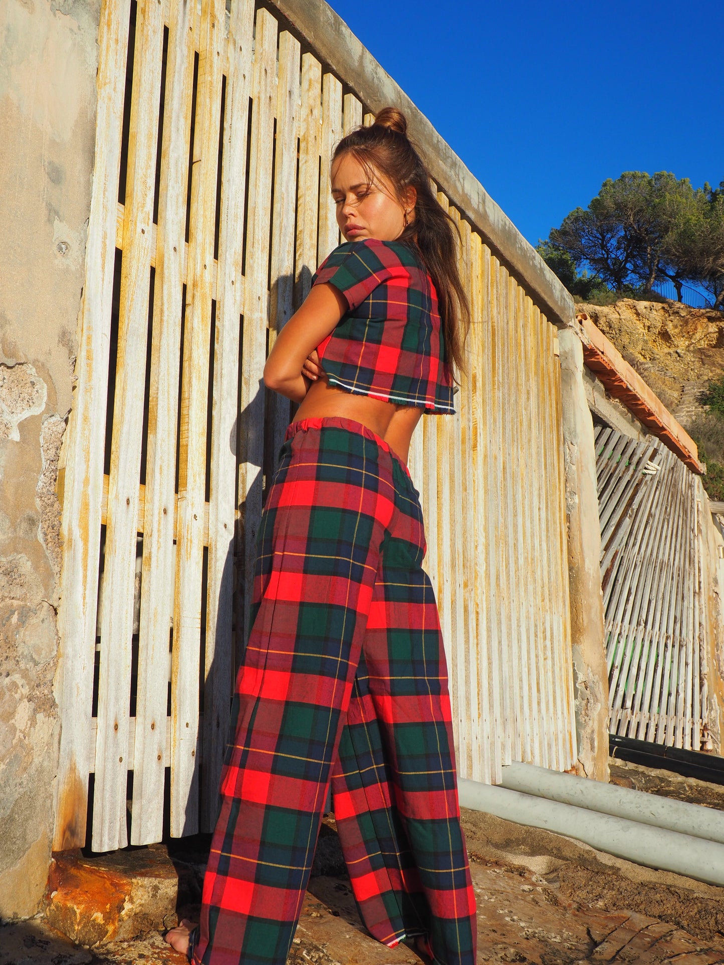 A stunning two-piece upcycled set featuring a vibrant red and blue checked design wide leg pants with elastic waste and crop top.