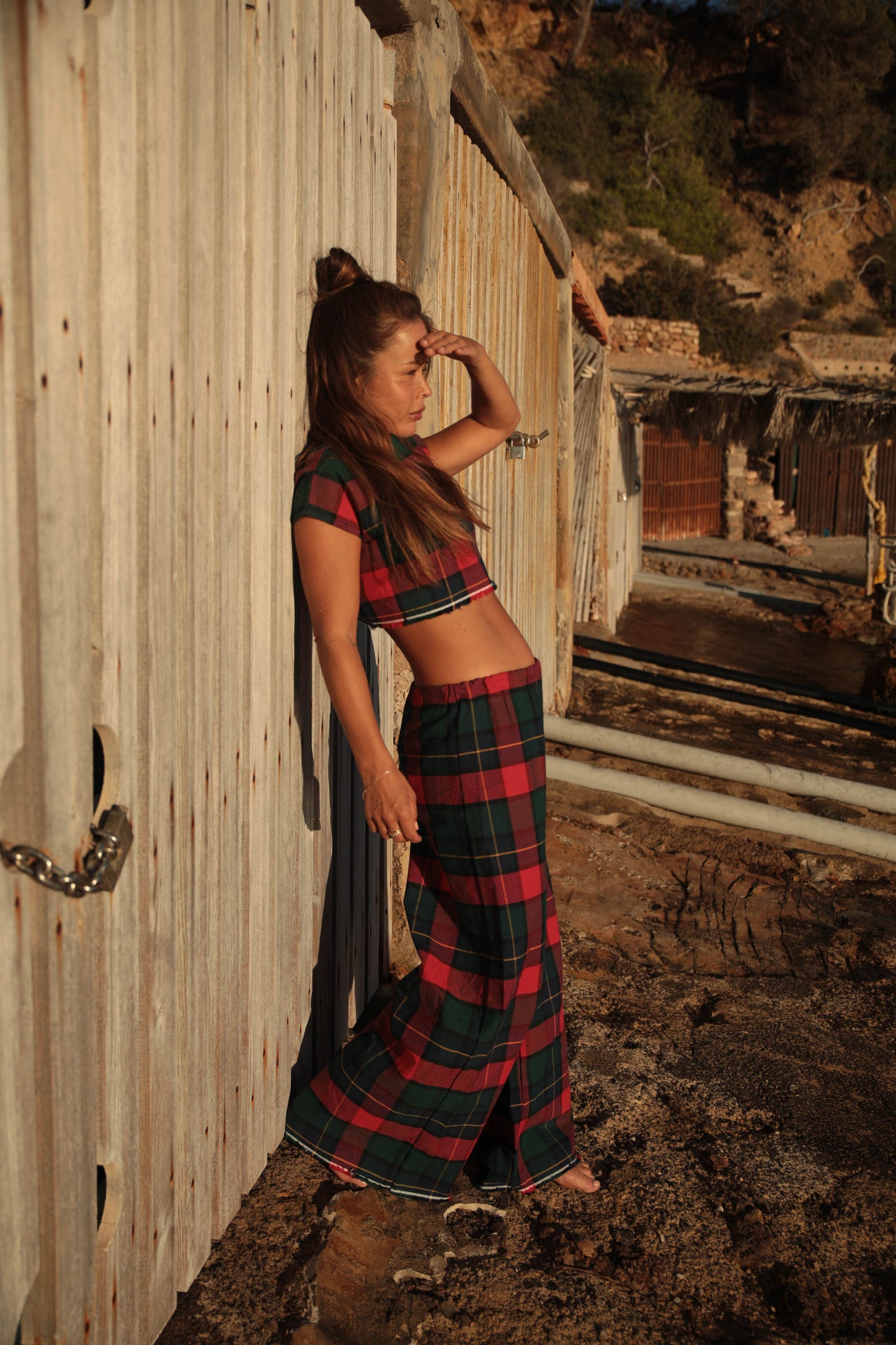 A stunning two-piece upcycled set featuring a vibrant red and blue checked design wide leg pants with elastic waste and crop top.