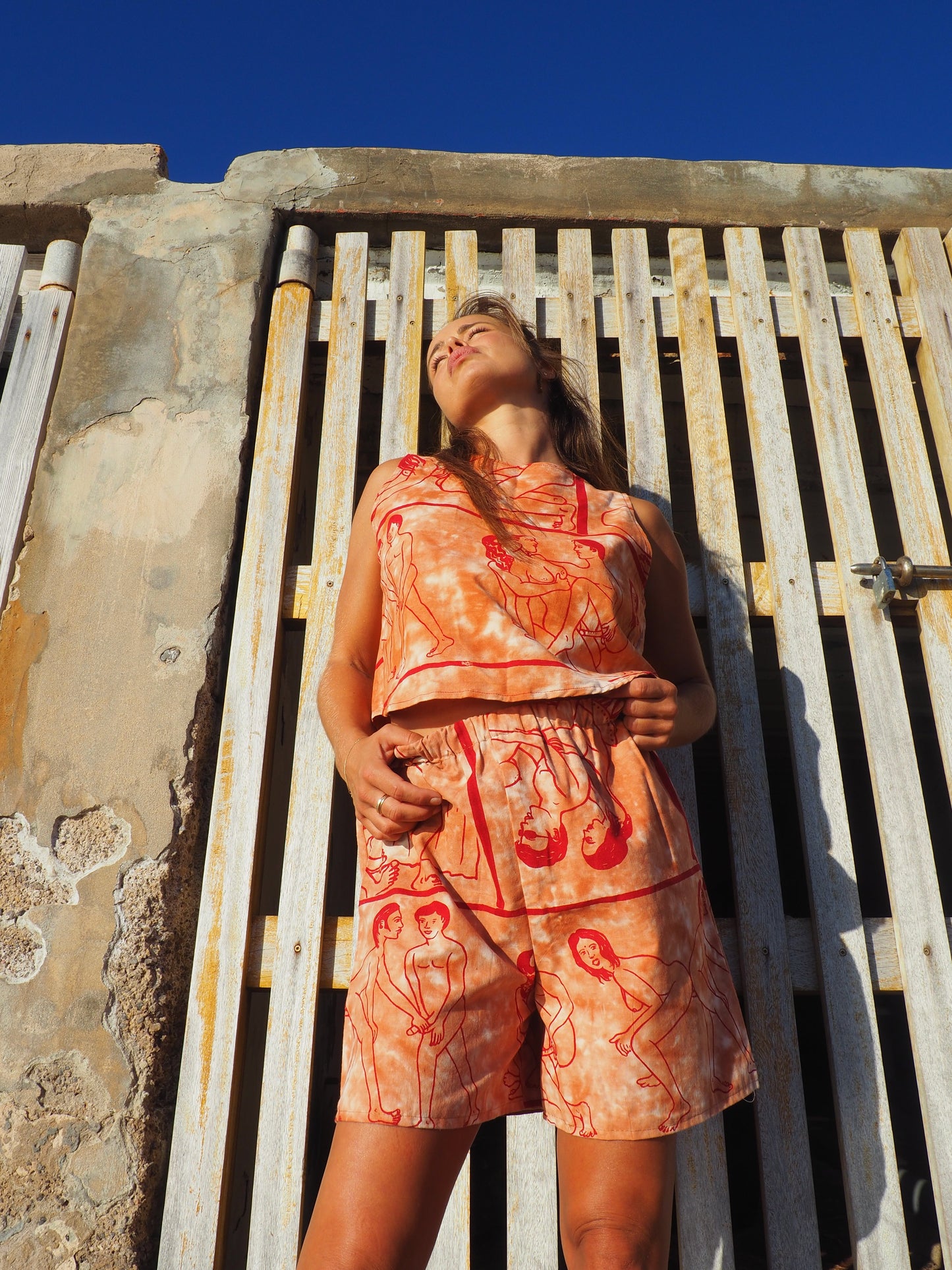 Up-cycled vintage cotton shorts with elastic waist and  printed karma sutra design in burnt orange.