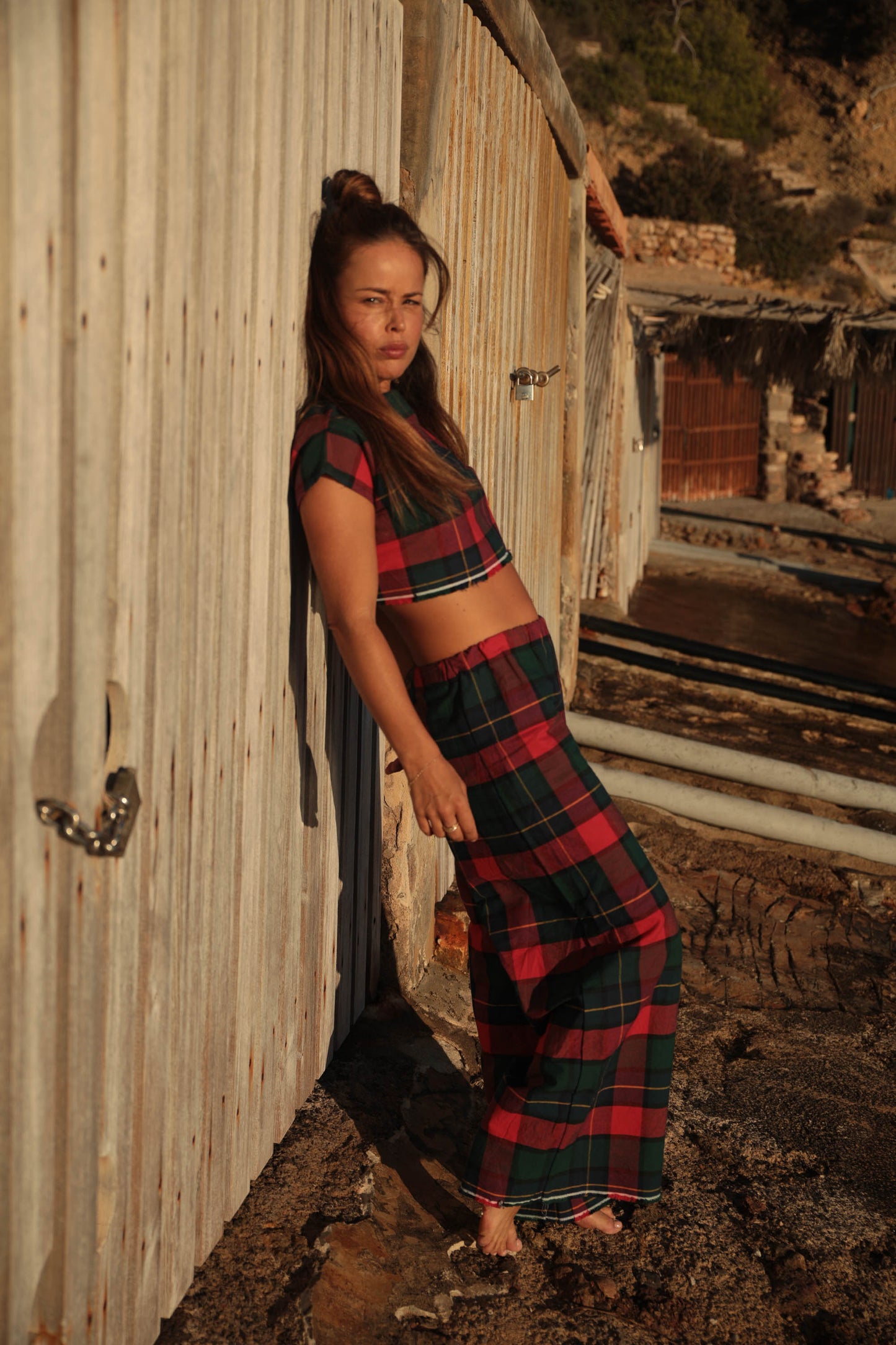 A stunning two-piece upcycled set featuring a vibrant red and blue checked design wide leg pants with elastic waste and crop top.