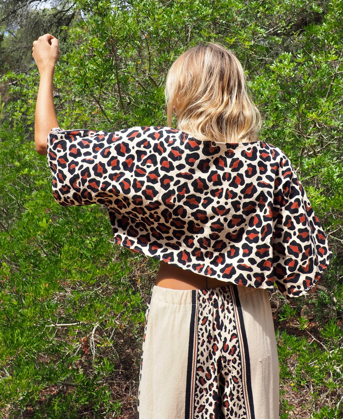 Up-cycled cotton black and cream animal print cropped top with sleeves made by Vagabond Ibiza