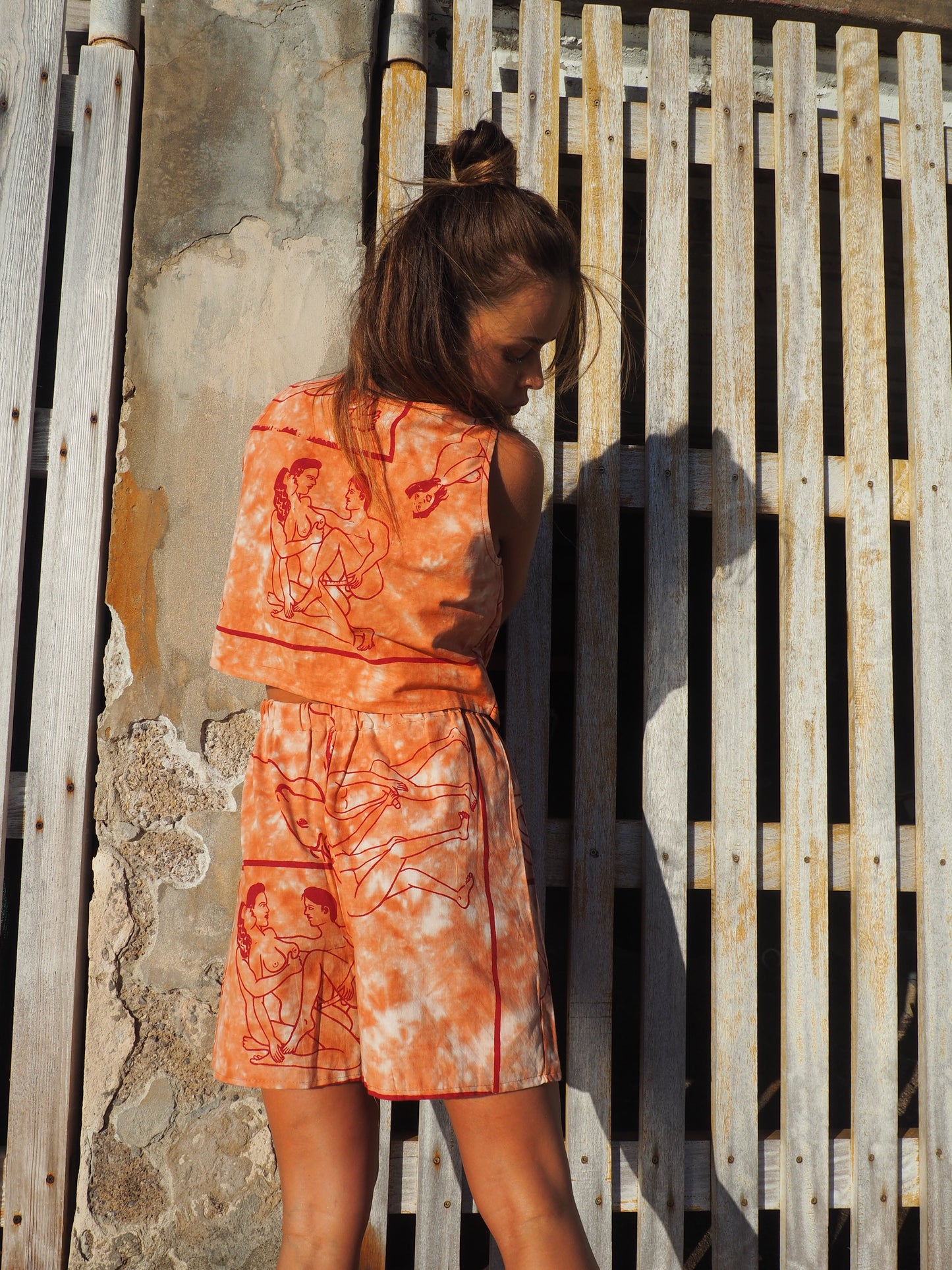 Up-cycled vintage cotton shorts with elastic waist and  printed karma sutra design in burnt orange.