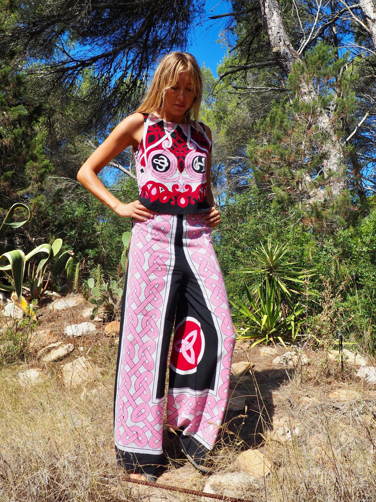 Up-cycled cotton short sleeve crop top in pink and black with vibrant print design and circular motifs by Vagabond Ibiza made