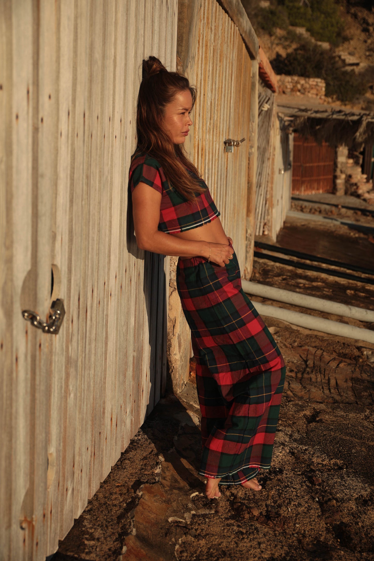 A stunning two-piece upcycled set featuring a vibrant red and blue checked design wide leg pants with elastic waste and crop top.