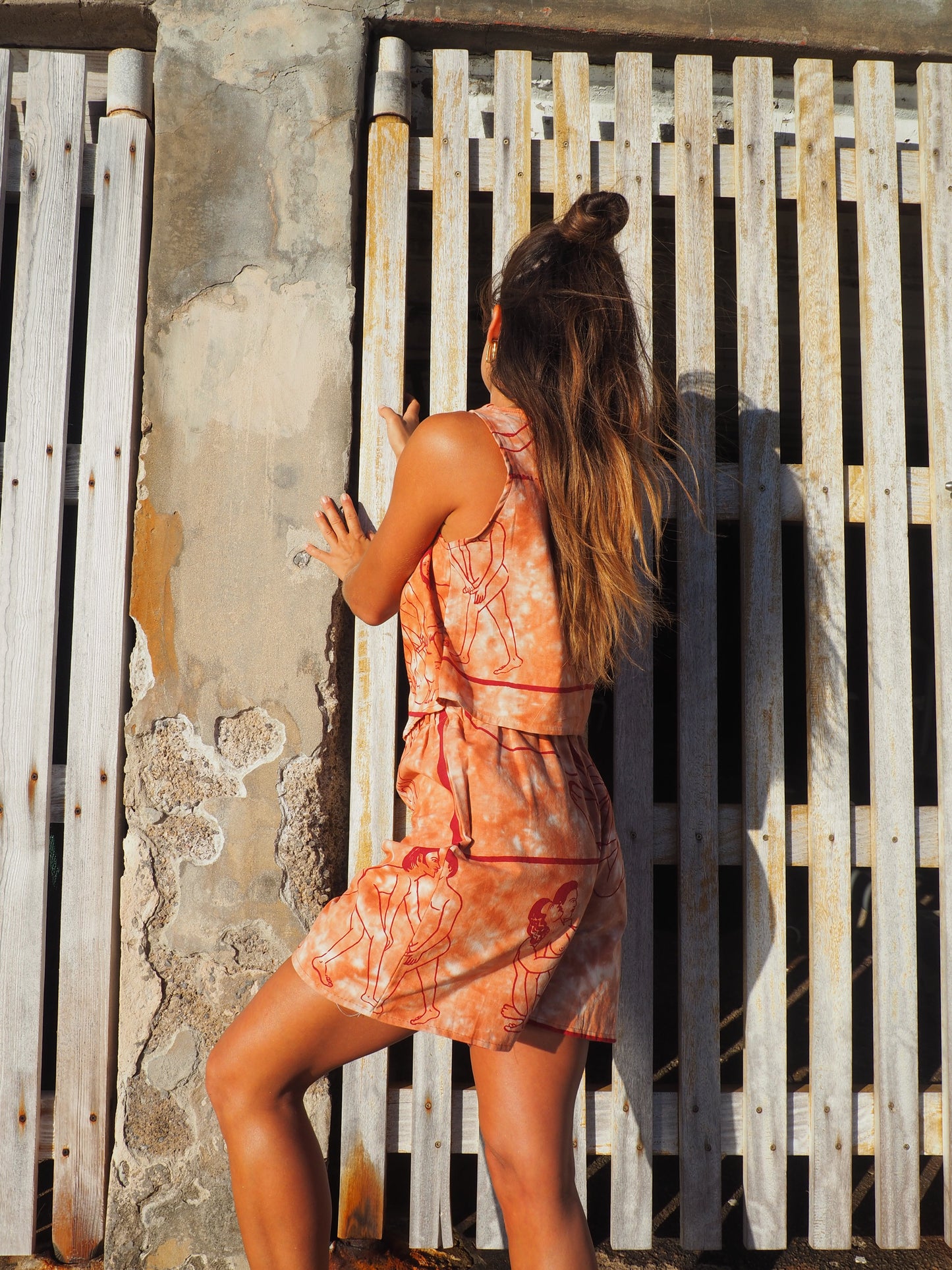 Up-cycled vintage cotton shorts with elastic waist and  printed karma sutra design in burnt orange.