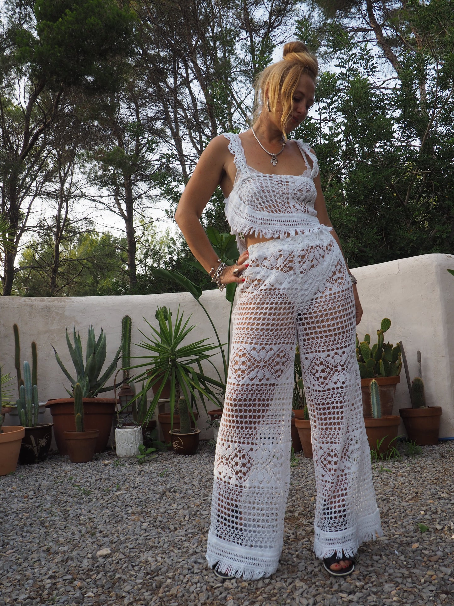Vintage white handmade crochet wide leg pants with elastic waist and fringing on the bottom