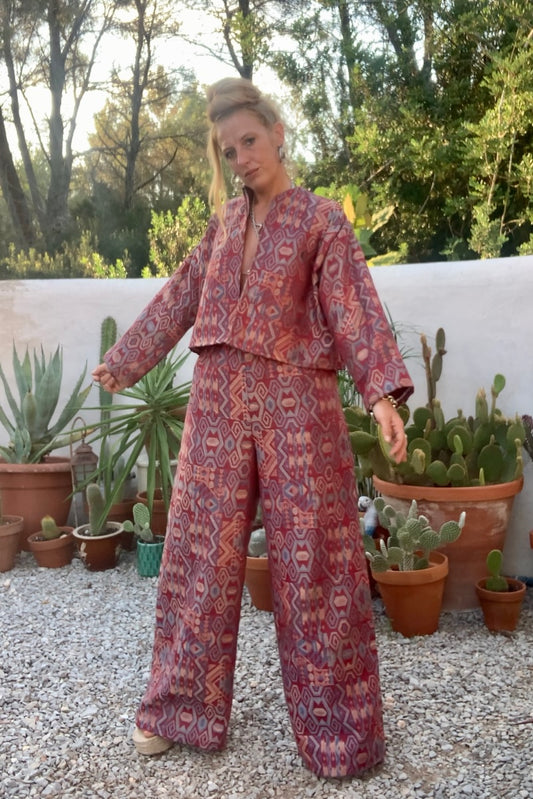 Very cool 2 piece sets made by Vagabond Ibiza from 1970’s upholstery fabrics in burgundy wide cropped long sleeve jackets and wide leg trousers with elastic waist