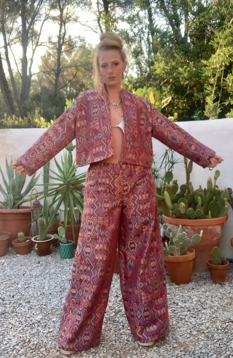 Very cool 2 piece sets made by Vagabond Ibiza from 1970’s upholstery fabrics in burgundy wide cropped long sleeve jackets and wide leg trousers with elastic waist