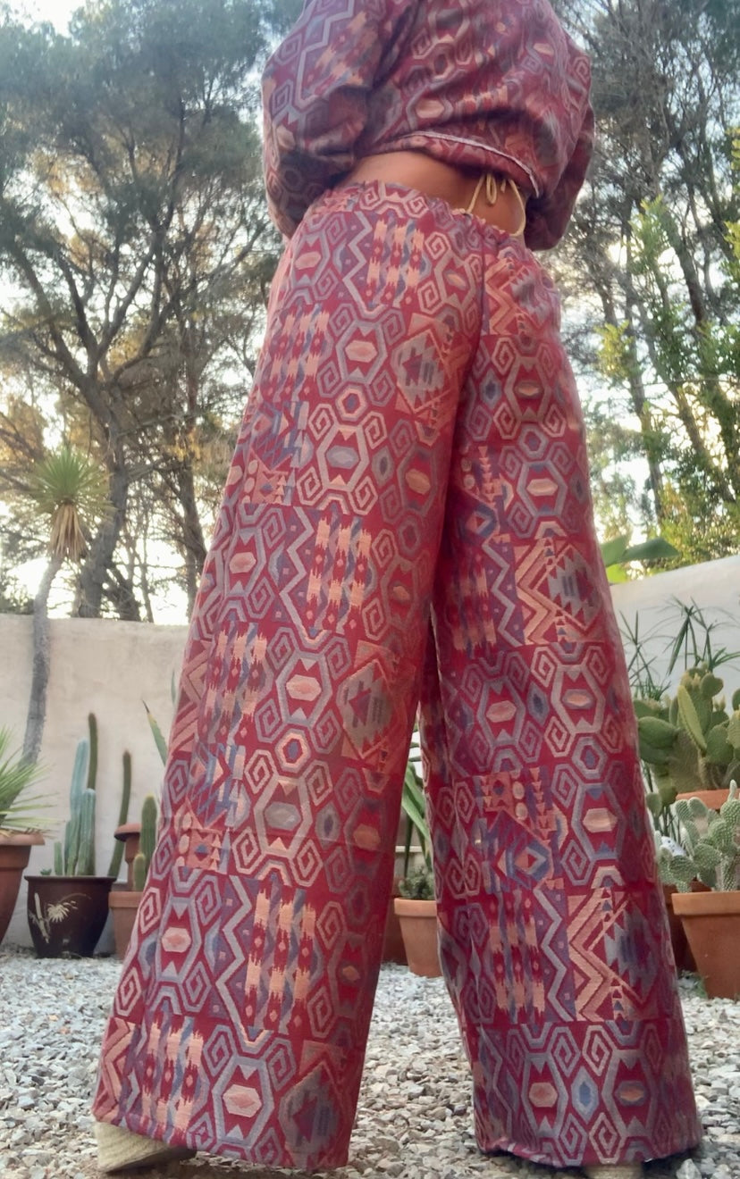 Very cool 2 piece sets made by Vagabond Ibiza from 1970’s upholstery fabrics in burgundy wide cropped long sleeve jackets and wide leg trousers with elastic waist