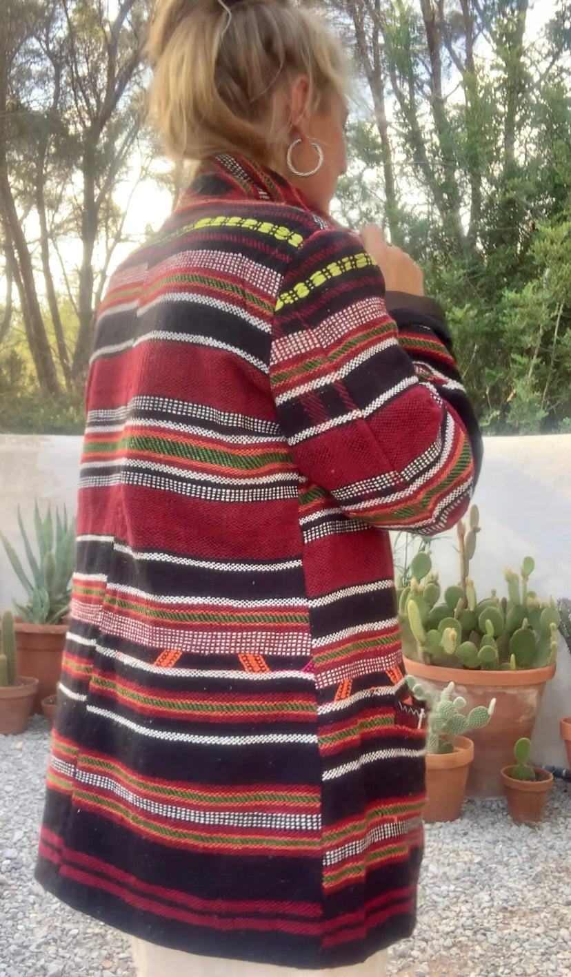 Original vintage woven Moroccan blanket jacket with red and black stripped design pockets and buttons up the front lined with black cotton